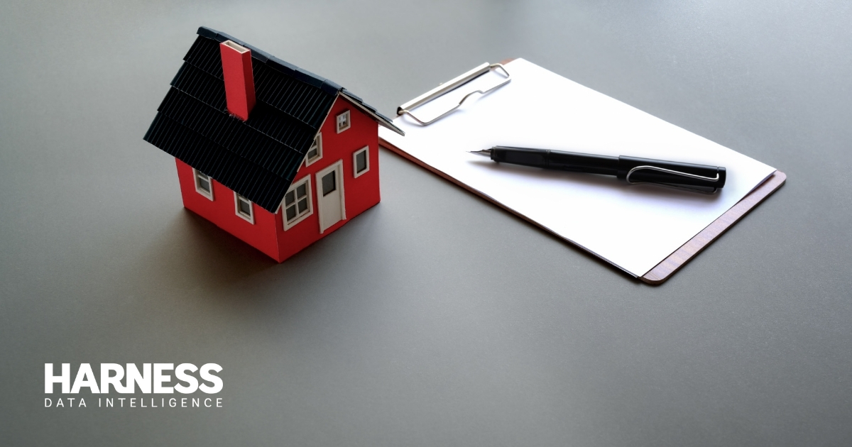 Model house next to a notebook and pen